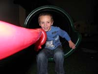 52-having_fun_on_the_slide_with_his_sword_balloon-he_wanted_Daddy_to_take_picture_as_he_slide_down