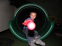53-having_fun_on_the_slide_with_his_sword_balloon-he_wanted_Daddy_to_take_picture_as_he_slide_down