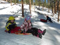 26-Abbe_having_fun_sledding-Kenny_pushes_the_sled_uphill