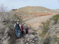 01-Poppy_Baba_and_Kenny_heading_down_slope_from_paved_road_to_Anniversary_Wash