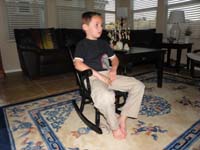 77-relaxing_in_rocking_chair_watching_Phineas_and_Ferb
