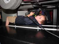 95-now_working_underneath_the_car-even_put_on_a_mechanics_shirt-he_liked_this_exhibit_the_best