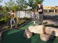 04-Kenny_climbing_rocks_while_Mommy_putts