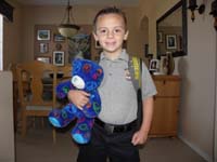 33-Kenny_with_Peace_Bear_for_Teddy_Bear_Picnic_at_school-note_scrap_on_forehead_from_playing_in_box