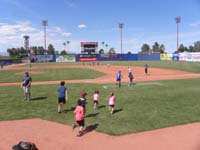 19-all_kids_get_to_run_the_bases_after_the_game-Kenny_is_one_with_red_hat_in_lower_center