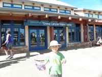 35-Kenny_showing_off_his_Junior_Ranger_program_and_badge_in_front_of_the_Visitor_Center