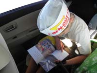 40-Kenny_wearing_In-N-Out_hat_while_reading_book_in_car_on_drive_home-Mommy_played_shuttle_to_North_Rim