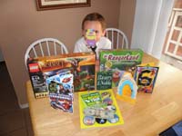 31-Kenny_and_his_presents-for_some_reason_he_wanted_to_put_the_sticker_on_his_nose