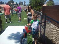 13-Kenny_working_the_table-make_a_water_bottle_fall_to_win_tickets_for_a_prize