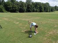 20-trying_his_luck_hitting_golf_balls_at_a_driving_range