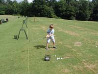21-trying_his_luck_hitting_golf_balls_at_a_driving_range