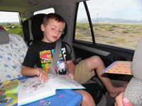 01-while_driving_to_Lassen,Kenny_reads_books_and_plays_road_trip_bingo