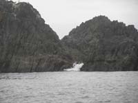 22-neat_surf_breaking_through_rocks