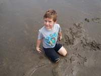 66-in_the_meantime_Kenny_gets_to_play_in_the_wet_sand_some_more-what_a_mess_to_clean_up