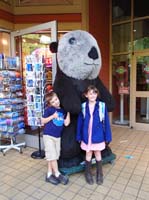 19-Kenny_and_Lorelei_pose_together_in_front_of_a_large_stuffed_panda