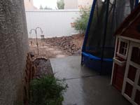 26-water_pooling_in_our_make-shift_wash-pipe_under_patio_to_flow_to_street