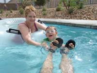 04-lazy_river_fun-Mommy_and_Kenny_riding_along_holding_Daddy's_shoes