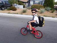 35-riding_his_bike-he's_getting_too_big_for_the_bike-new_one_probably_on_his_next_birthday