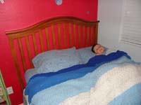 26-Kenny_all_tucked_into_bed_on_a_cold_winters_night_with_tooth_on_bed_post