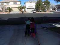 43-wrapped_rope_around_Daddy_and_tied_to_recycle_bin-Kenny_and_Sarina_push_down_driveway