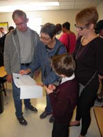 26-Kenny_explains_his_science_fair_paper_to_Poppy,Baba,Mommy