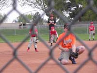 20-Kenny_at_second_base-Daddy_coaching_behind-forgot_about_wearing_baseball_hat_on_brimmed_hat