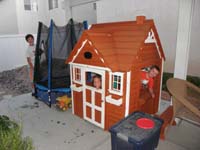22-Toby,Sierra,Kenny_having_fun_playing_in_the_little_house_outside