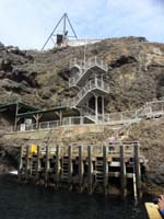 020-the_stairs_to_climb-boat_pushes_against_dock_riding_the_waves_for_people_to_get_off