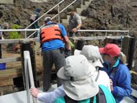 021-Kenny_gets_off-one_person_at_a_time-step_when_boat_rises_to_proper_level