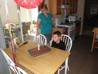 11-ready_to_blow_out_his_candle_on_the_birthday_cake_Mommy_made