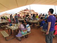 17-busy_lunch_area-school_yard_style_sitting-Kenny's_happy_he_gets_to_climb_some_rocks