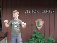 22-Kenny_shows_off_his_badge-we_bought_an_extra_patch-Junior_Ranger_badge_number_34