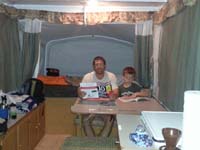 24-Daddy_and_Kenny_reading_in_the_camper