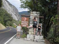 02-family_at_Yosemite_NP_entrance_sign-Hwy_120_just_opened_after_rock_slide_due_to_rain_in_park