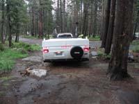 03-Kenny's_picture-campground_muddy-tight_fit_backing_up_between_rock_and_tree_to_flat_ground