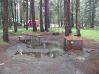 04-Kenny's_picture-still_drizzling-our_campsite_has_pool_of_water_in_front_of_bear_food_locker
