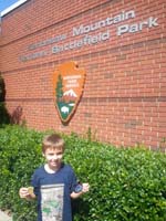 106-showing_off_his_Junior_Ranger_badges_for_Kennesaw_Mountain_National_Battlefield_Park