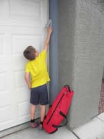01-Kenny_is_now_tall_enough_to_be_able_to_enter_the_code_for_our_garage_door_opener