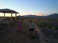 09-Zoe_and_Kenny_riding_bikes_on_Tule_Springs_trail_after_sunset_on_a_school_night