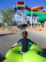 17-Kenny_is_a_big_help_carrying_the_tube_to_the_top_of_the_slide-he_wanted_to_be_in_front