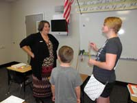 11-Kenny_at_his_desk_meeting_his_teacher_Mrs_Warner
