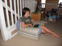 37-relaxing_watching_a_show_on_the_Kindle_in_his_'Kenny_chair'-hard_day_after_running_triathlon