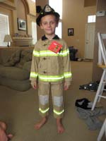 58-Kenny_likes_his_Halloween_costume-a_fireman-although_a_little_short