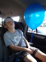 77-hard_fun_day-sleeping_on_the_drive_home_still_holding_his_balloon