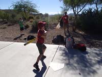 03-hard_to_keep_eye_on_ball_as_Jason_pitches_with_his_son_Evan_above_Kenny's_head