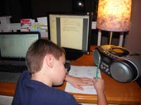 20-Kenny_doing_his_math_homework_at_Mommy's_desk-no_book,electronic_book