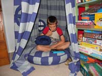 46-Kenny_watching_a_video_in_his_tent_in_his_room