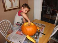 32-Kenny_has_fun_pulling_out_the_guts_of_the_pumpkin