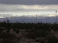 26-neat_clouds_in_distance_over_Red_Rock_due_to_cold_front_blowing_through