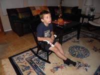 07-he_likes_to_cuddle_with_the_bear_Baba_made-Mommy_won't_let_him_keep_it_at_our_house-getting_big_for_chair